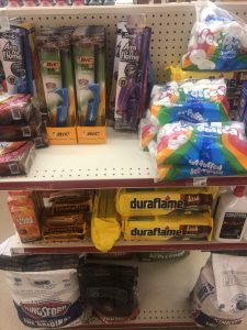 Store shelf display with BIC lighters in blue and purple packaging and Jet-Puffed marshmallows on the right.