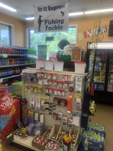 Store display of fishing tackle with hooks, lures, and line on a pegboard under a banner reading 'Rt 17 Express Fishing Tackle'.